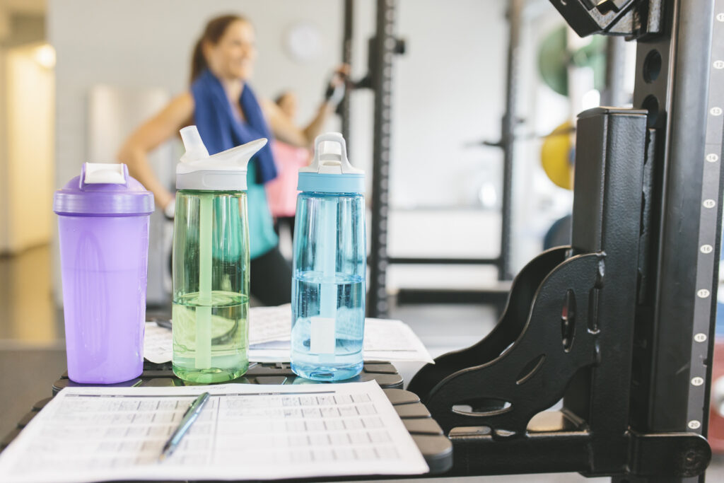 Shaker bottles with woman working out in the background